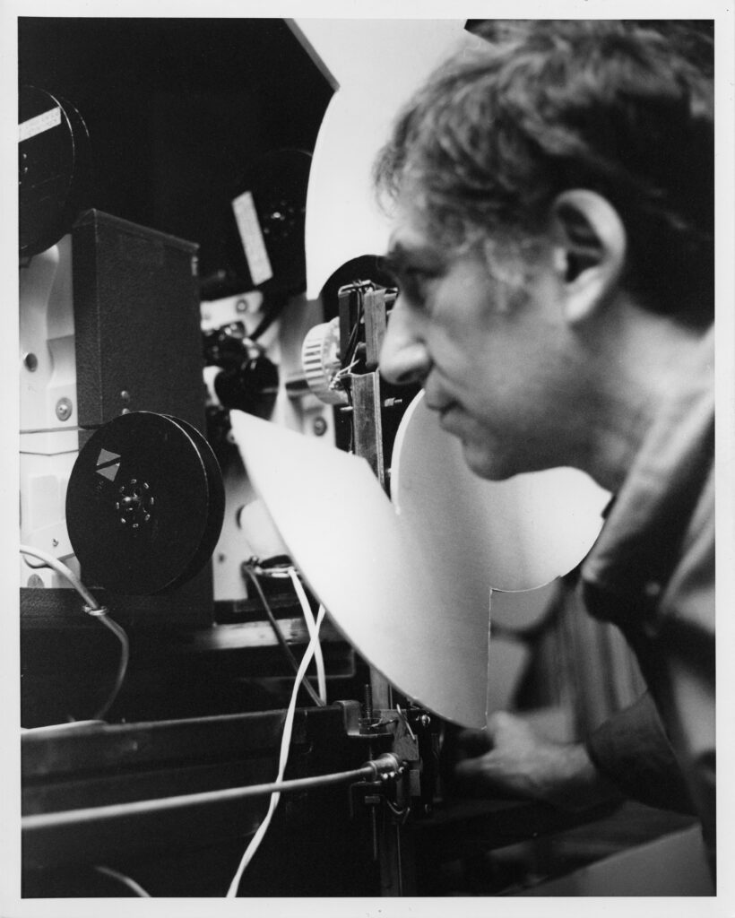 Ken Jacobs inspecting one of his projectors, ca. 1995
